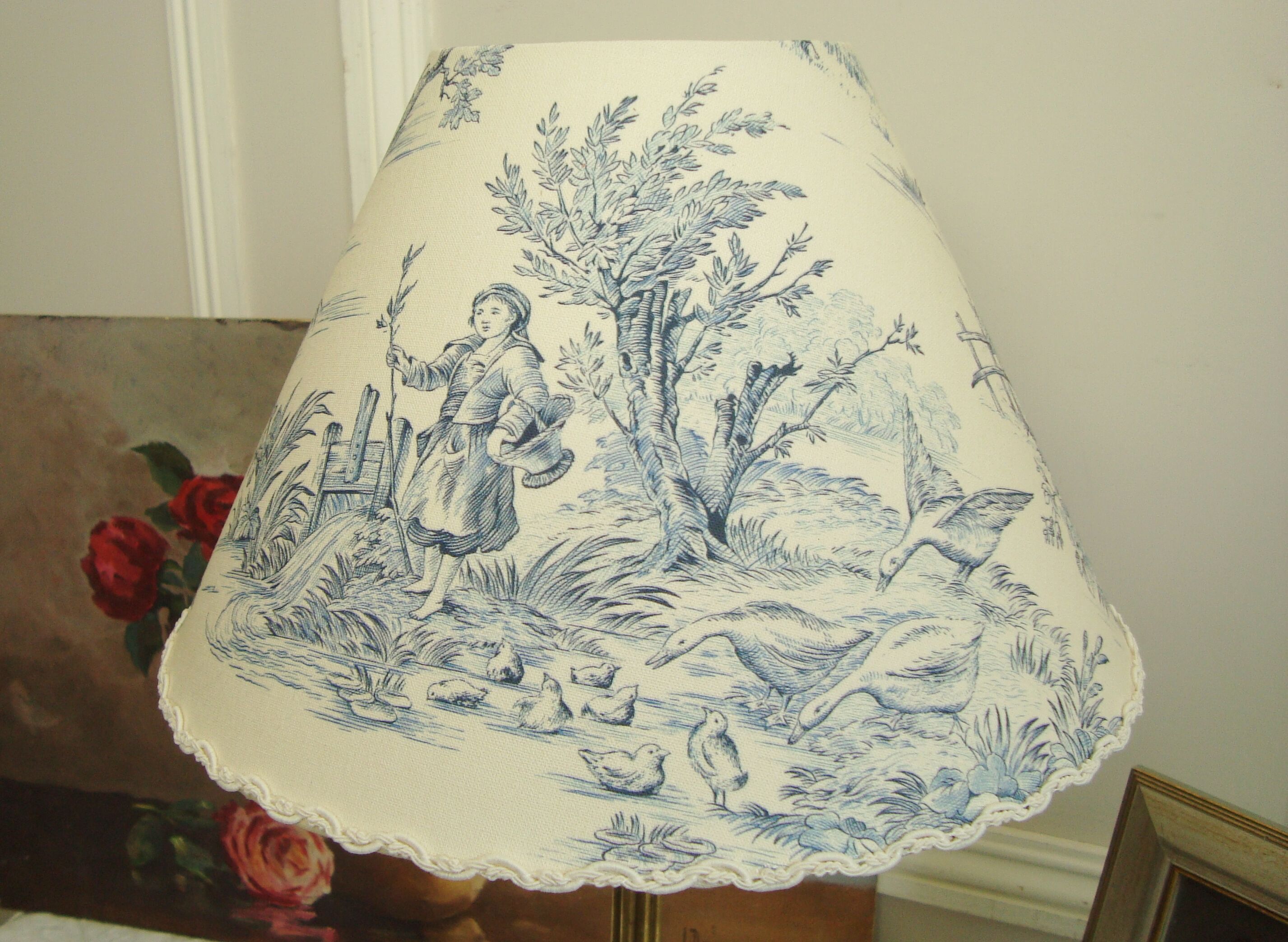 Ancient bronze lamp with its blue Jouy canvas lampshade
