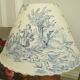 Ancient bronze lamp with its blue Jouy canvas lampshade
