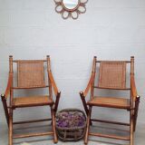 Pair of folding chairs in bamboo and caning, leather and brass