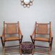 Pair of folding chairs in bamboo and caning, leather and brass