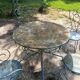 Table + 2 chairs and 2 outdoor iron armchairs.
