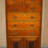 Victorian high chest of drawers in walnut with a bronze gallery.