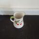 Small ancient porcelain pitcher decorated with cherries
