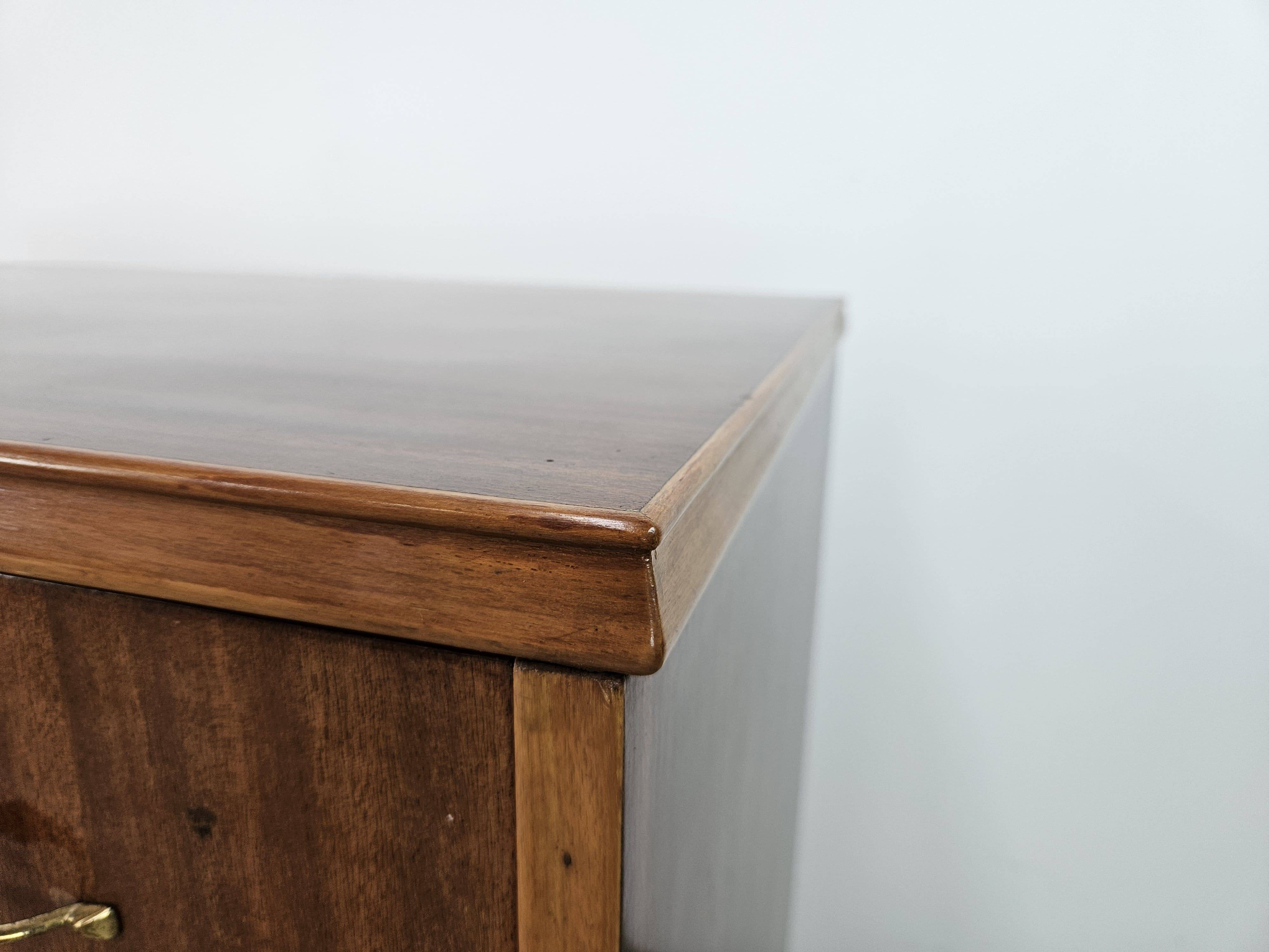 1950s chest of drawers covered in walnut with brass handles