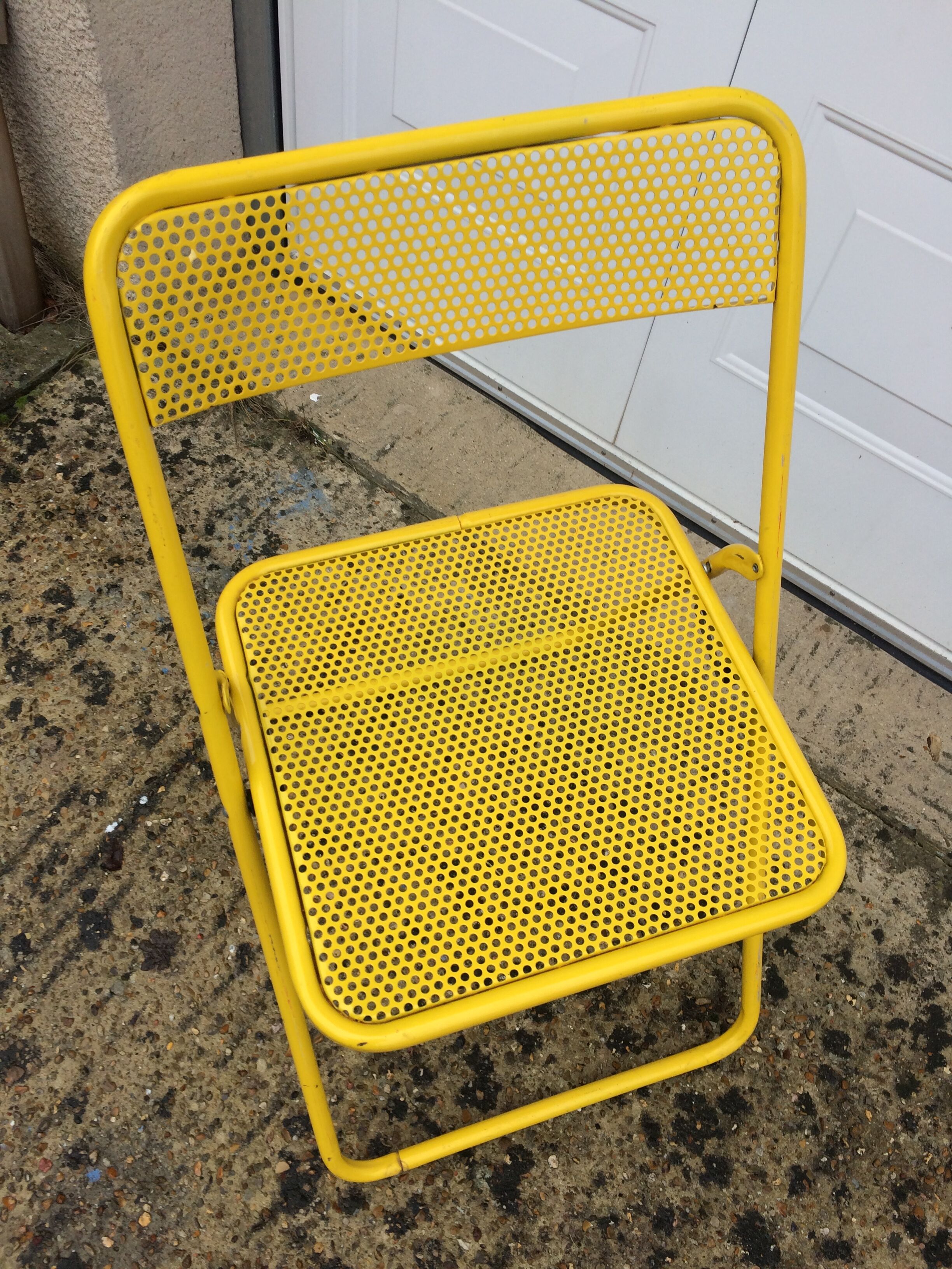 Perforated folding metal chair