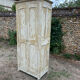 Small antique wardrobe with a faded white patina.