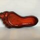 Red ceramic footprint catchall.