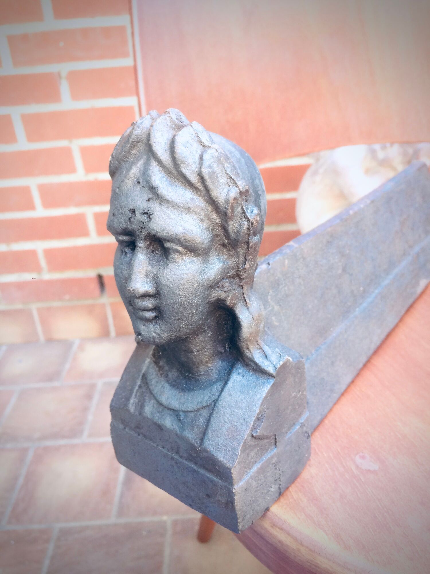 Pair of cast-iron chenet characters with laurels