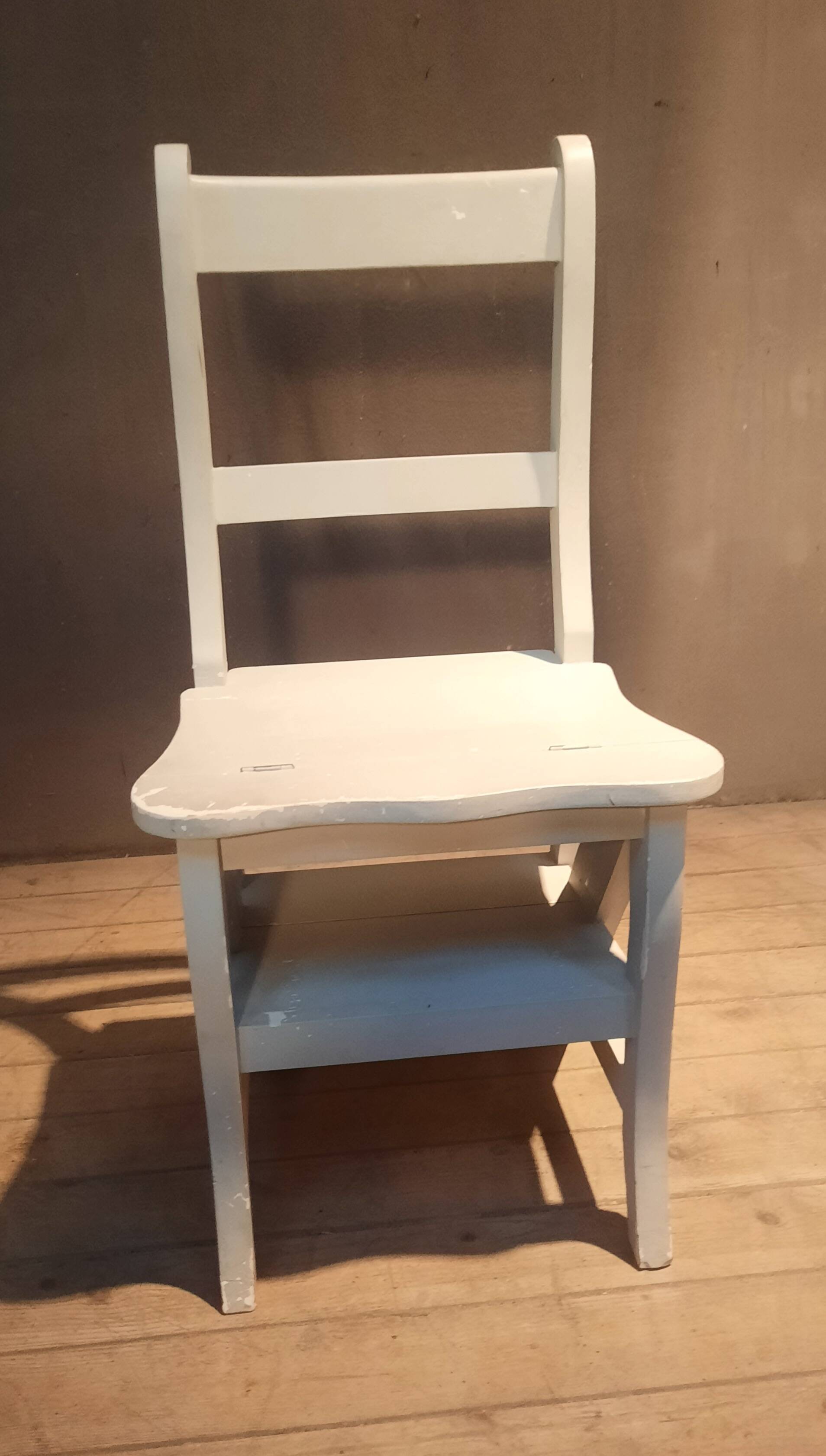 White chair convertible into a staircase.