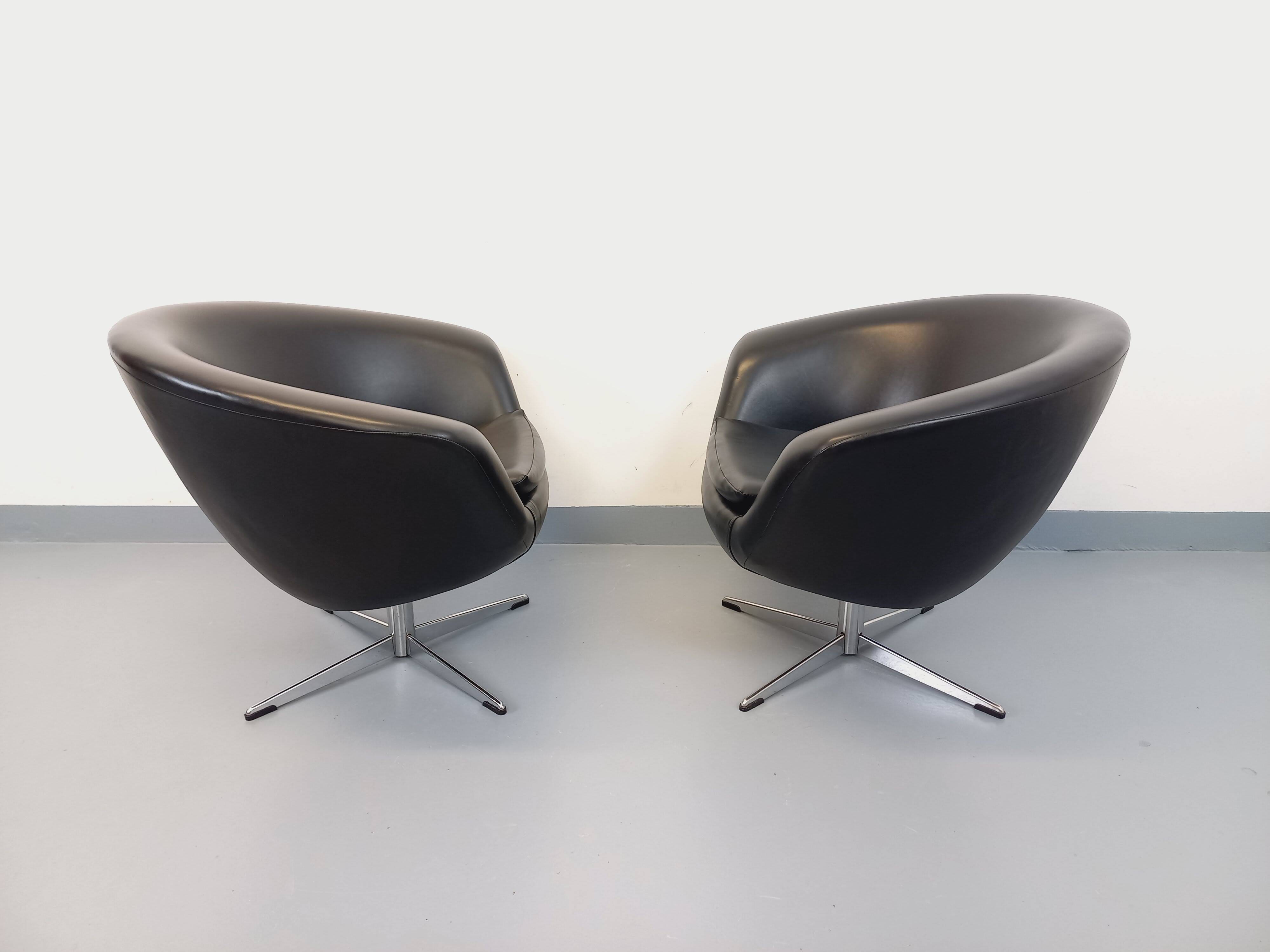 Pair of vintage Scandinavian swivel armchairs in faux leather and chrome.