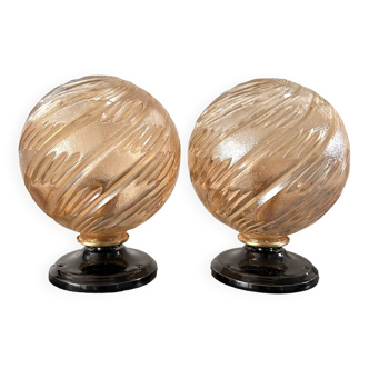 Pairs of golden globe wall lights in chiseled glass