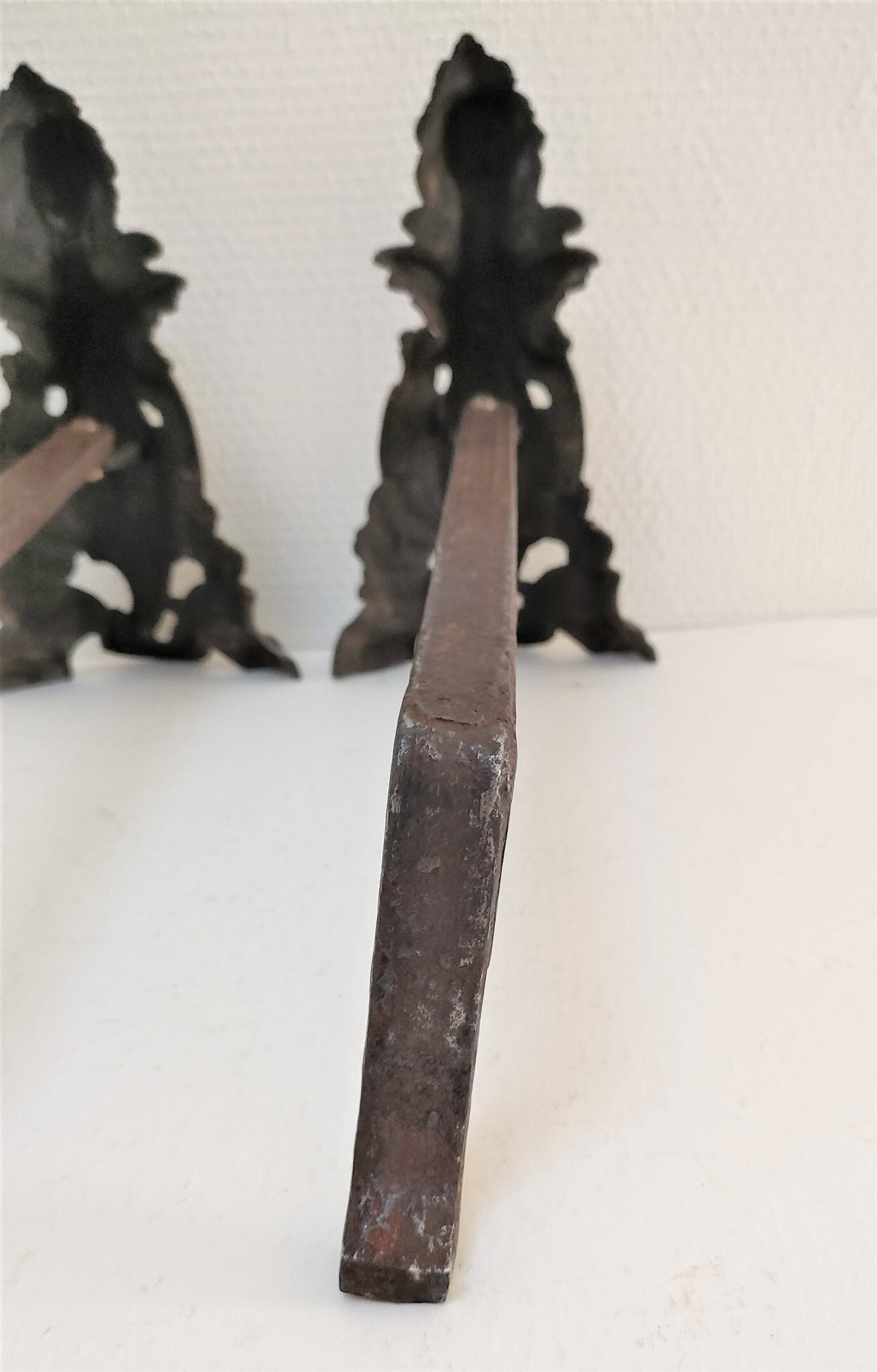 Pair of bronze andirons with black patina, 19th century, female caryatids