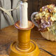 Candle holder-style lamp made entirely of ceramic.