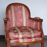 Pair of Louis XVI style armchairs in walnut and pink silk and ecru