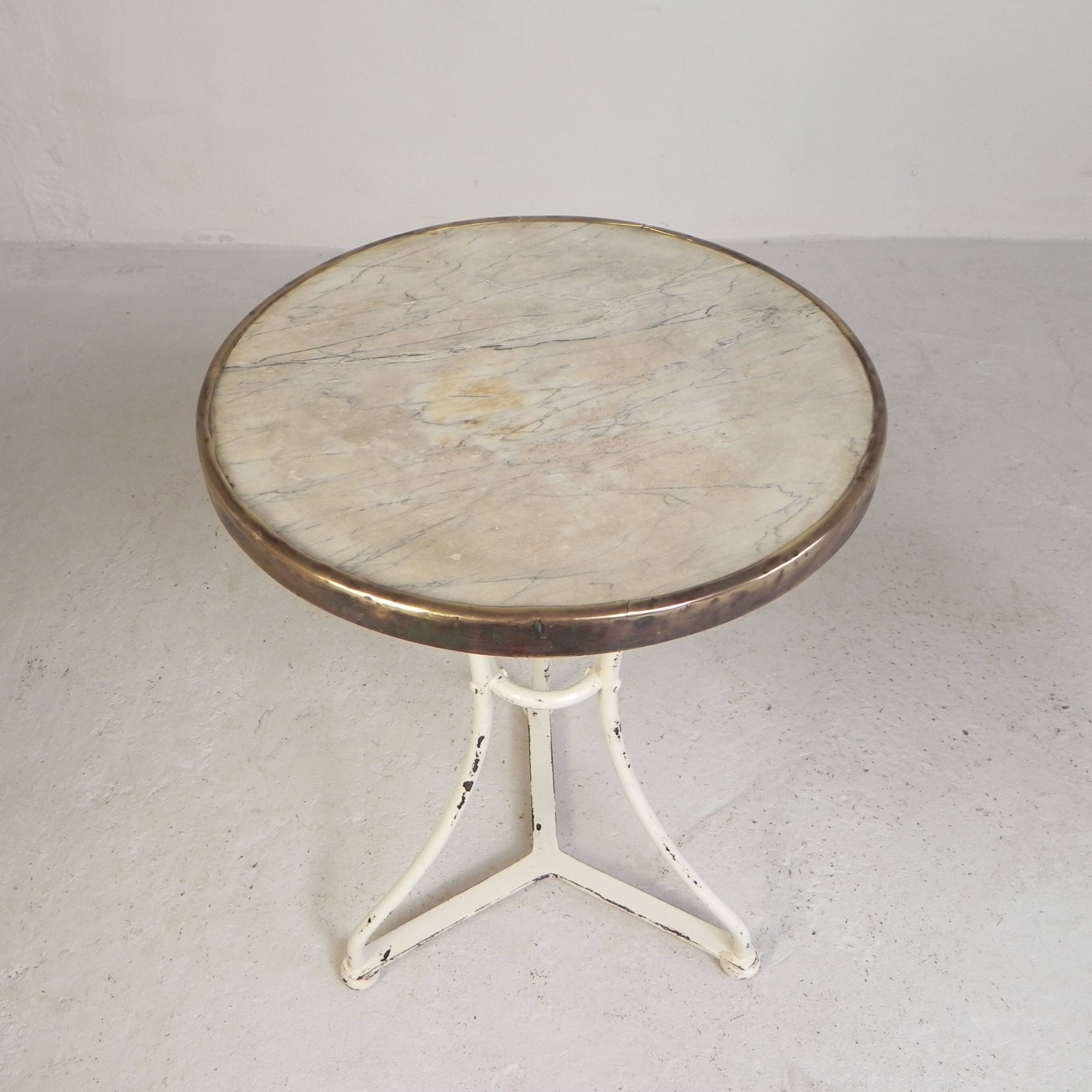 Bistro table with a marble top and brass edging, early 20th century.