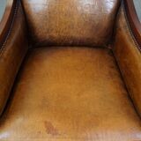 Sheepskin and wooden vintage Art Deco design armchair in a cognac color
