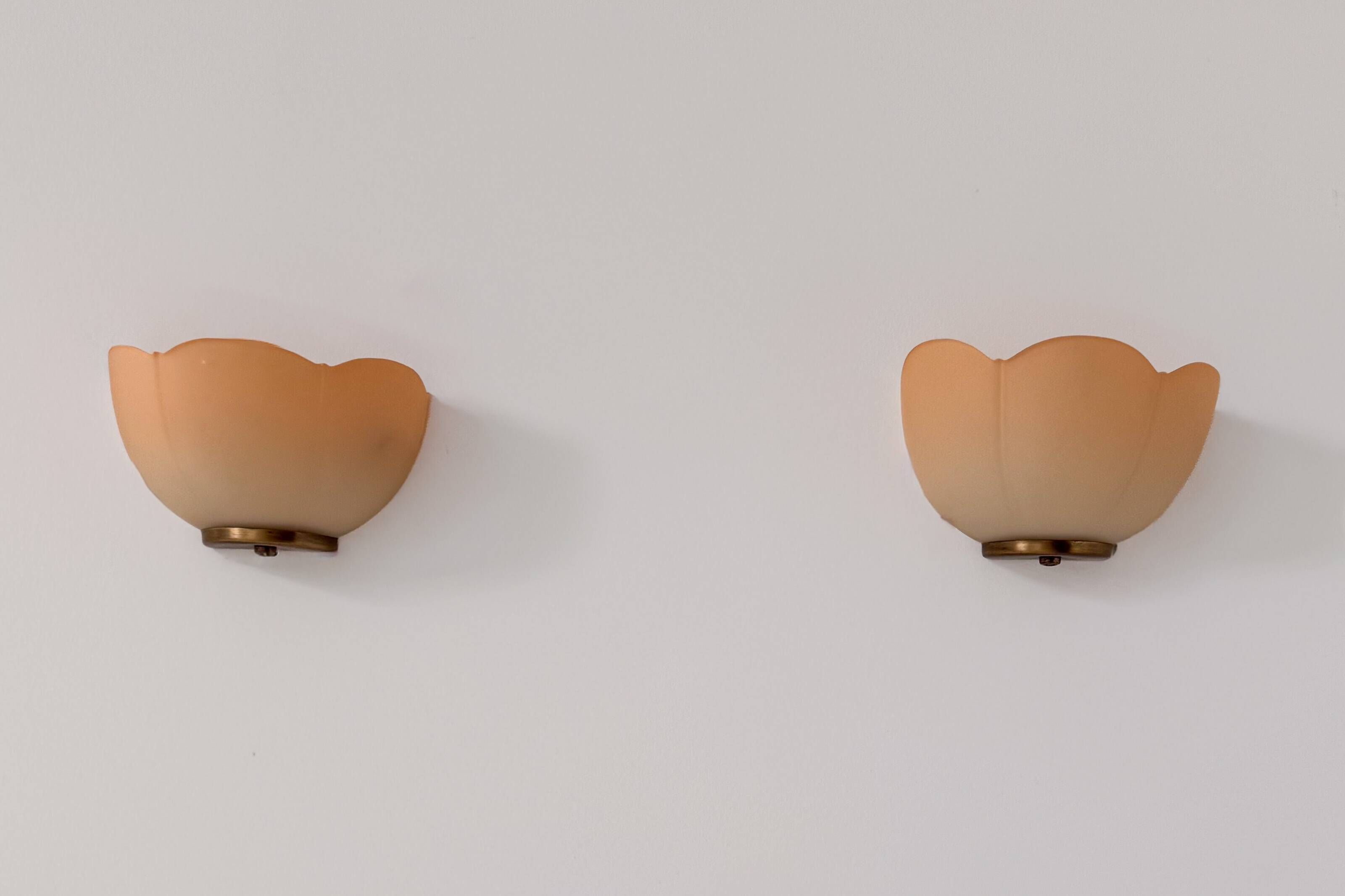 Vintage brass and orange glass wall sconces, France 1970.