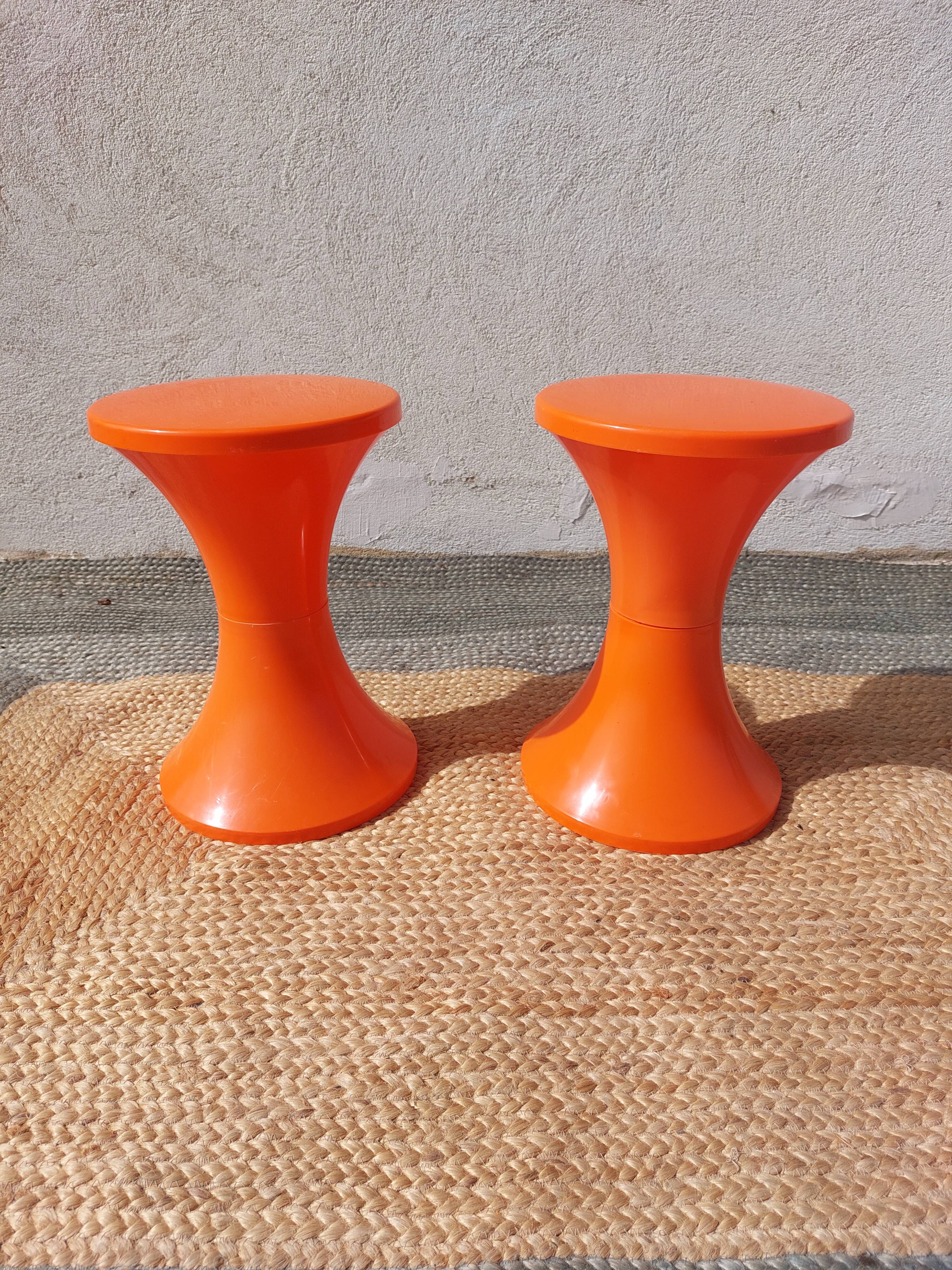 pair of orange tam-tam stools