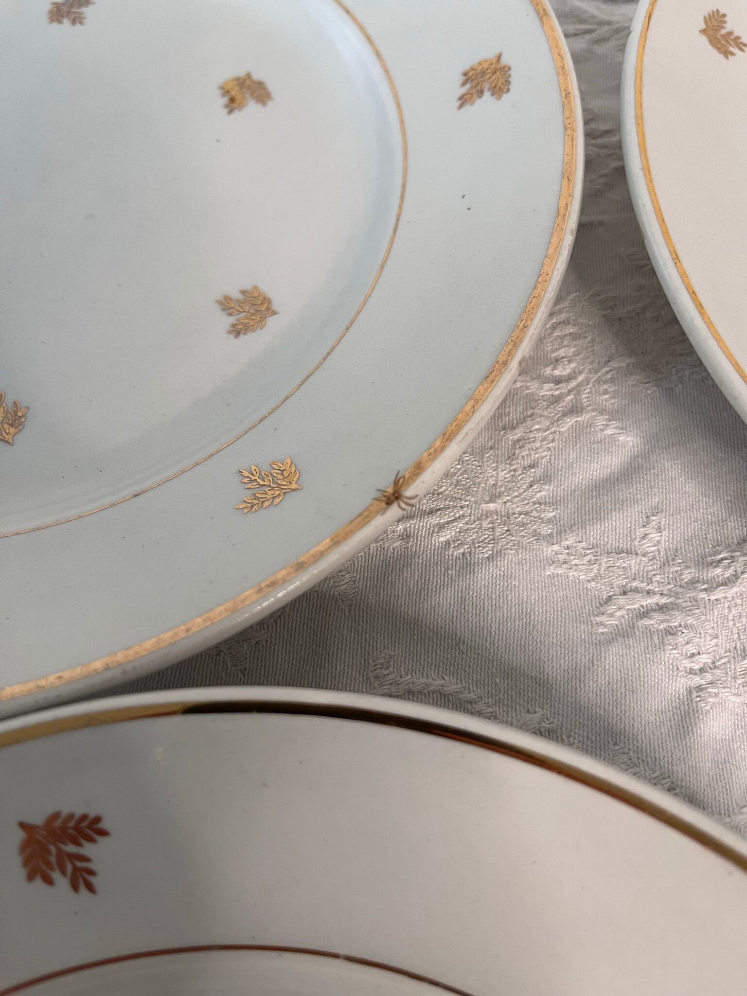 11 plates in antique earthenware decorated with golden leaves and golden border