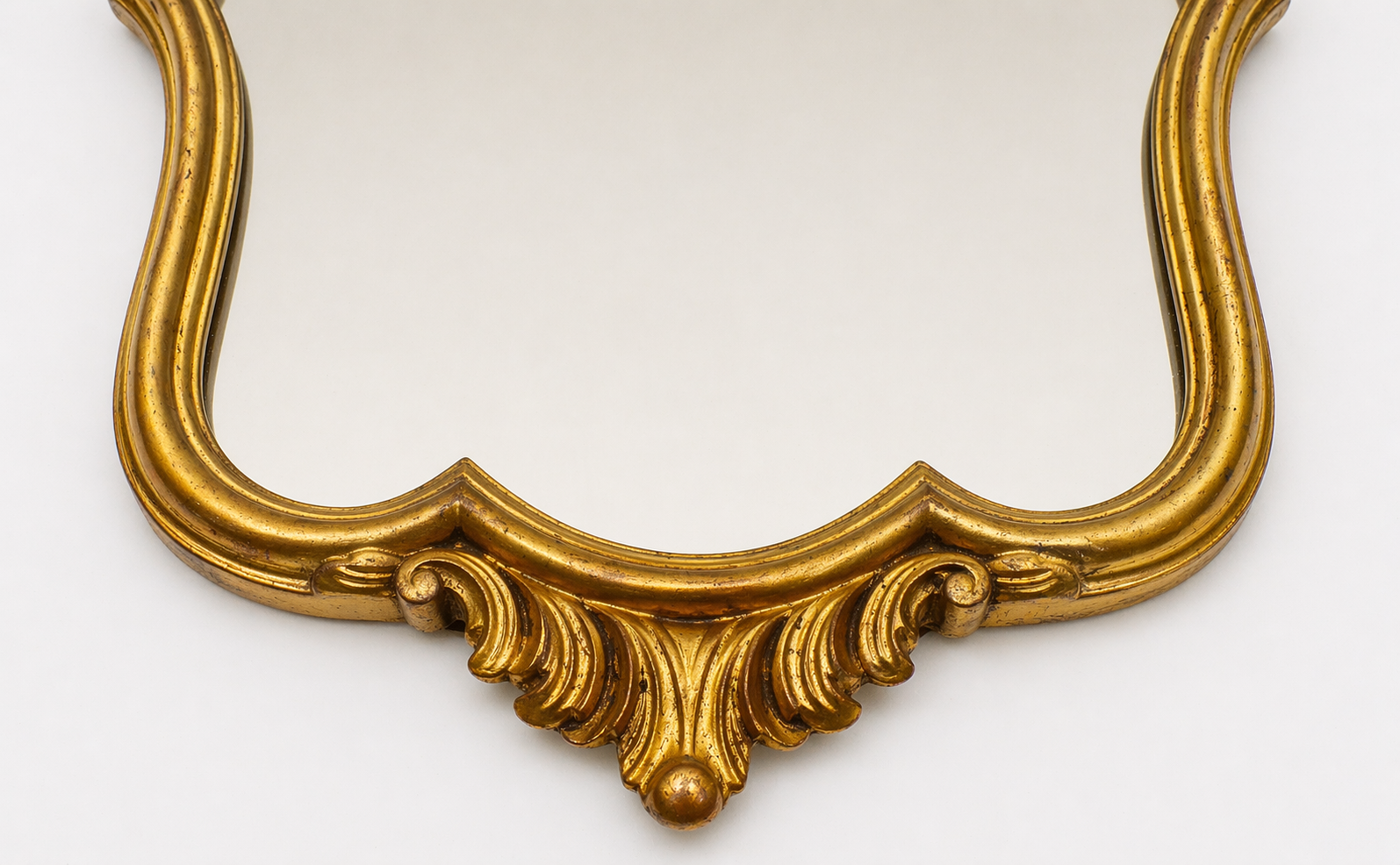 Golden wooden wall mirror in Louis XV style, shell-shaped rocaille decoration, circa