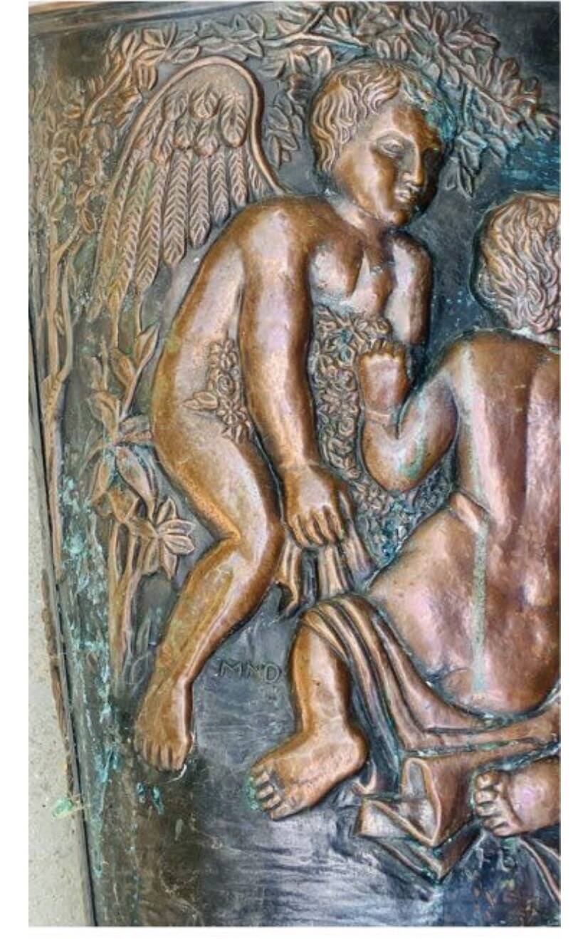 Antique red copper umbrella stand decorated with putti angels.