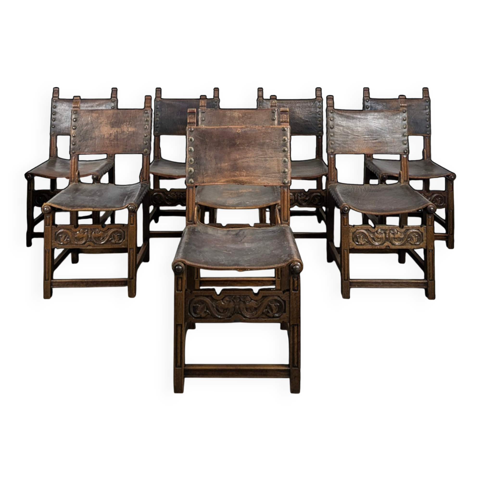 Set of 8 Gothic-style chairs in oak and studded leather.