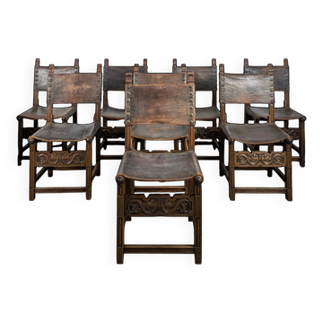 Set of 8 Gothic-style chairs in oak and studded leather.