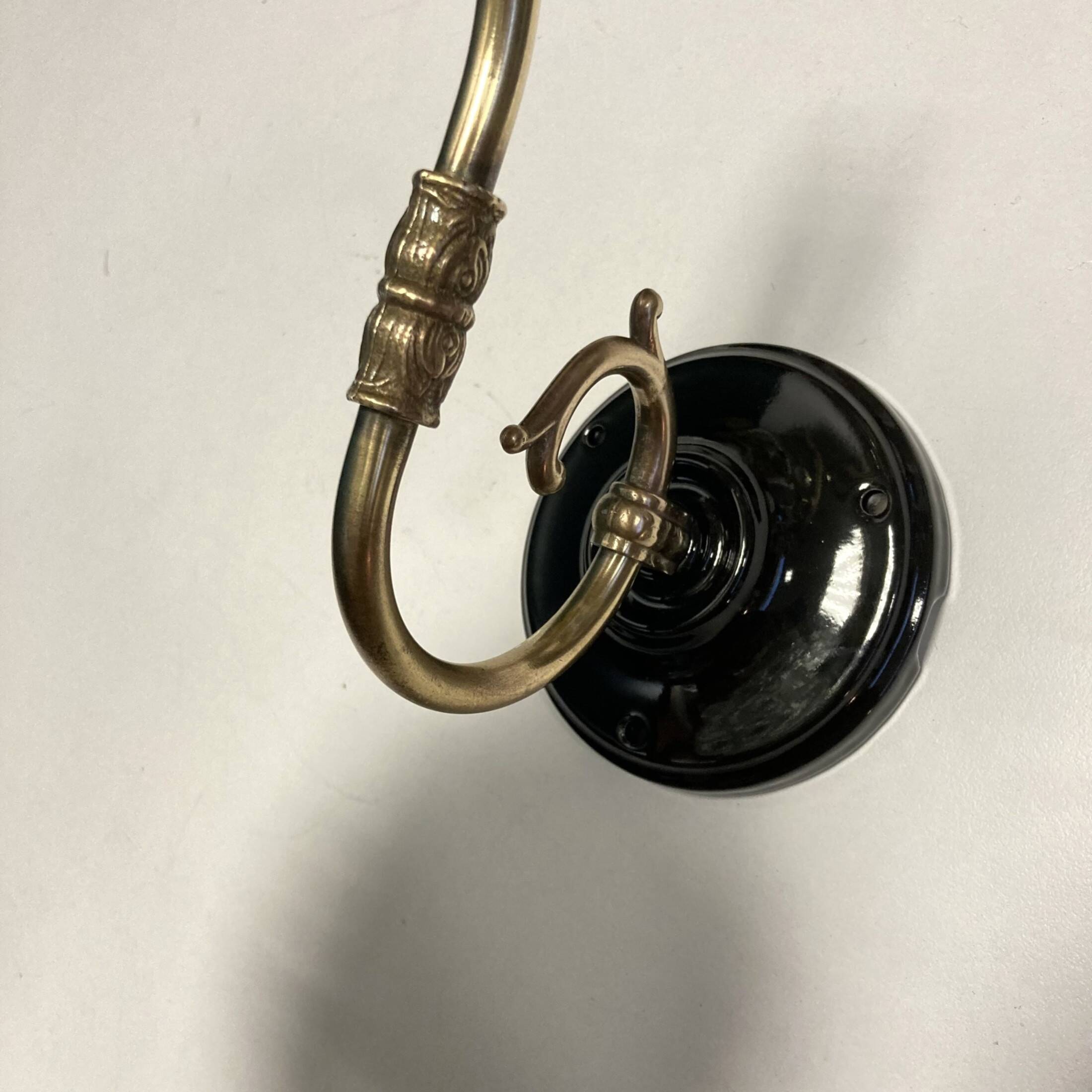 Pair of old swan neck wall lights in brass and transparent glass globe