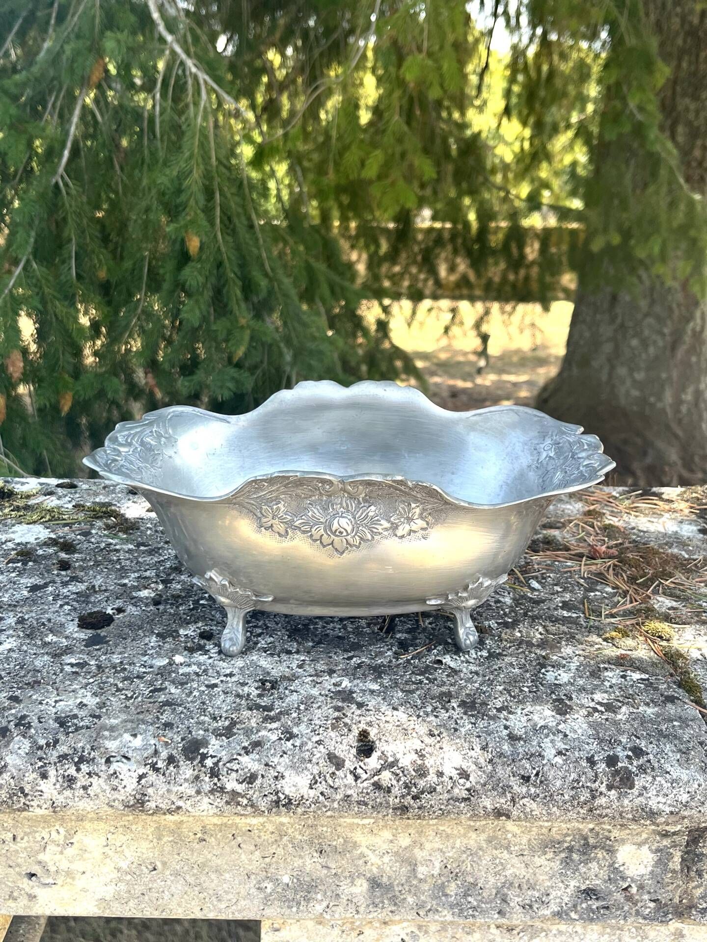 Footed pewter champagne cooler on claw feet with floral relief