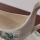 Gravy boat with white and green earthenware handle