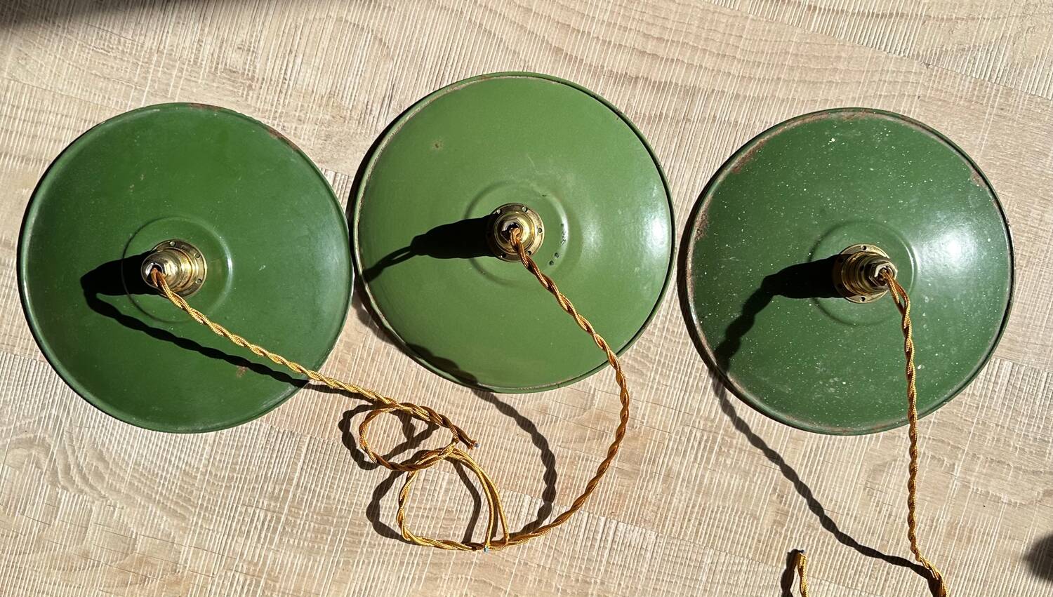 Trio of vintage green enamelled sheet metal lampshade pendants