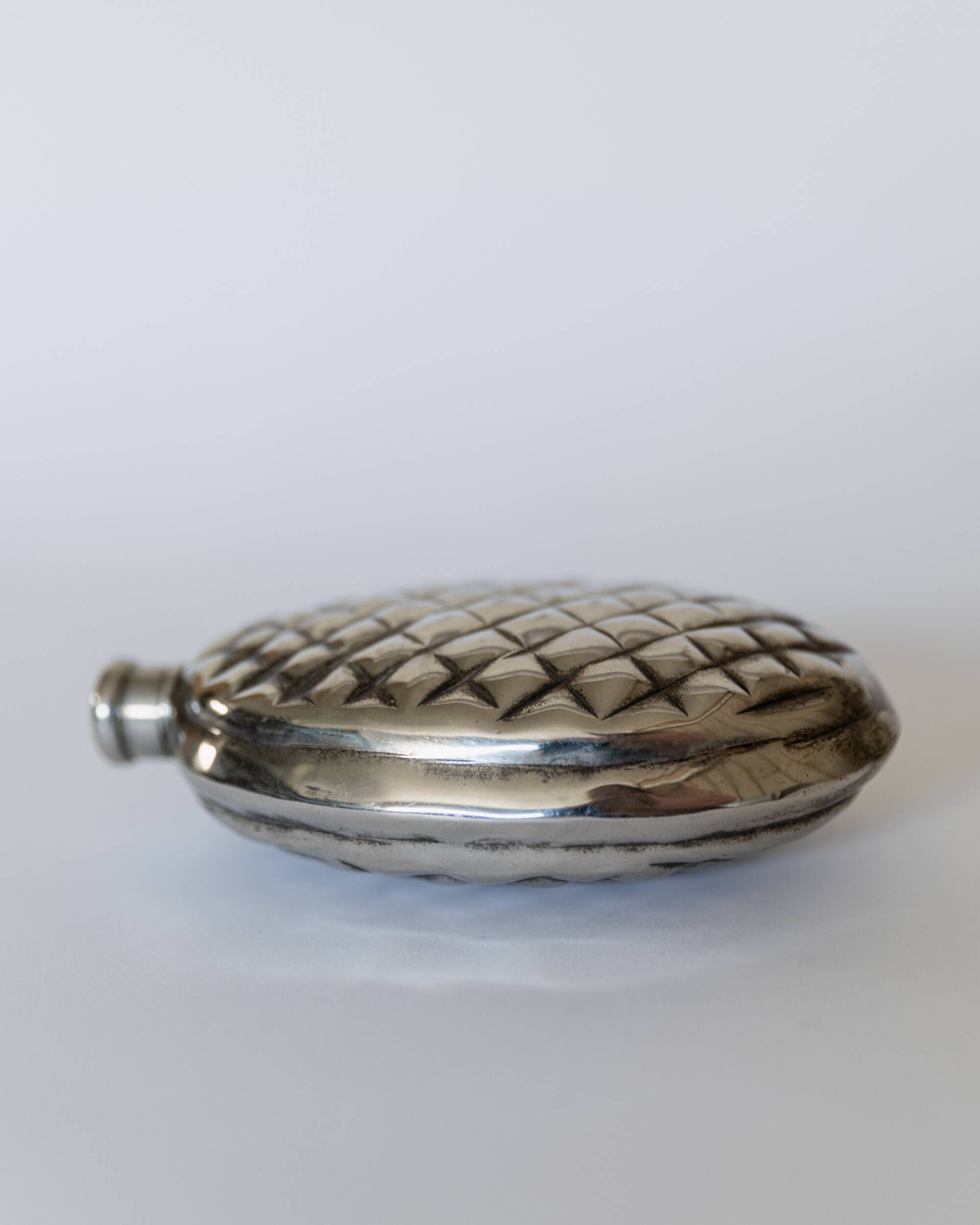 Vintage 1950s silver-plated flask in the shape of a pine cone.