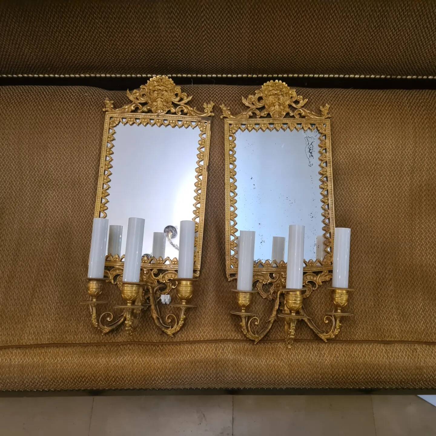 Pair of wall lights with mirror backgrounds with 3 arms of lights in chiseled and gilded bronze. framing decorated with foliage and masks. louis xiv style