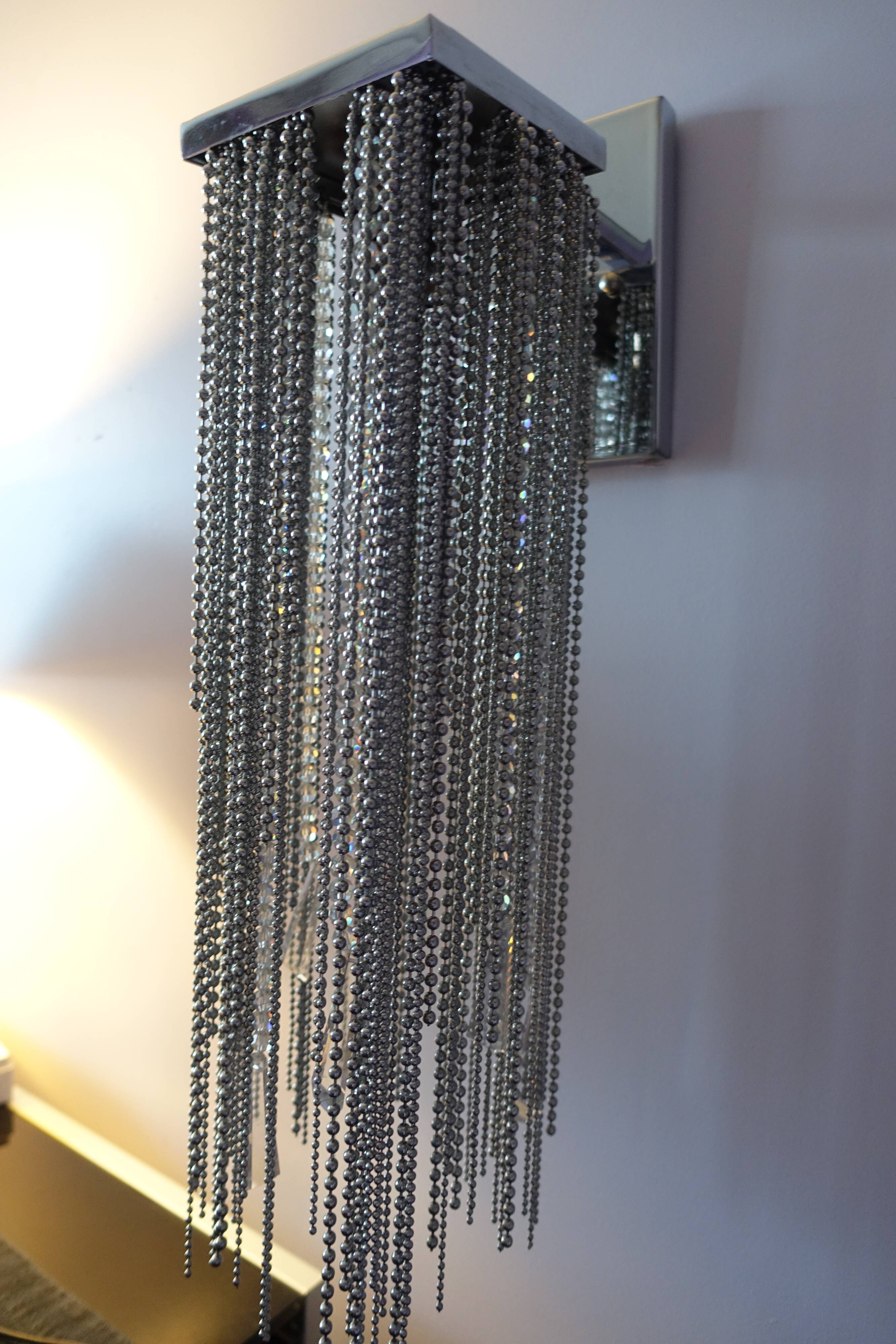 Swarovski wall lamp in silver-plated metal with crystal pendants.