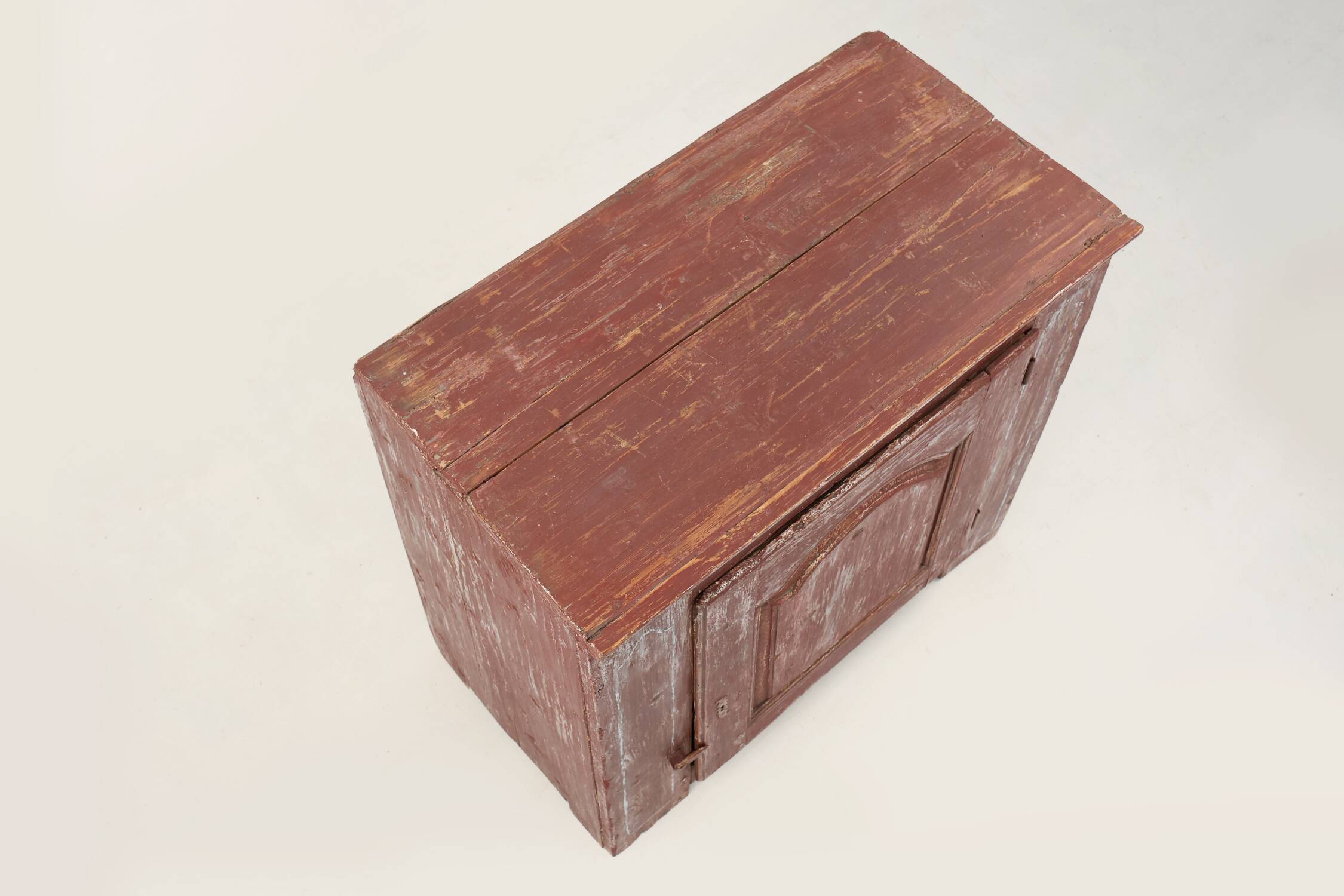 Rustic Parisian cabinet in pine wood with old burgundy paint layers, ca. 18