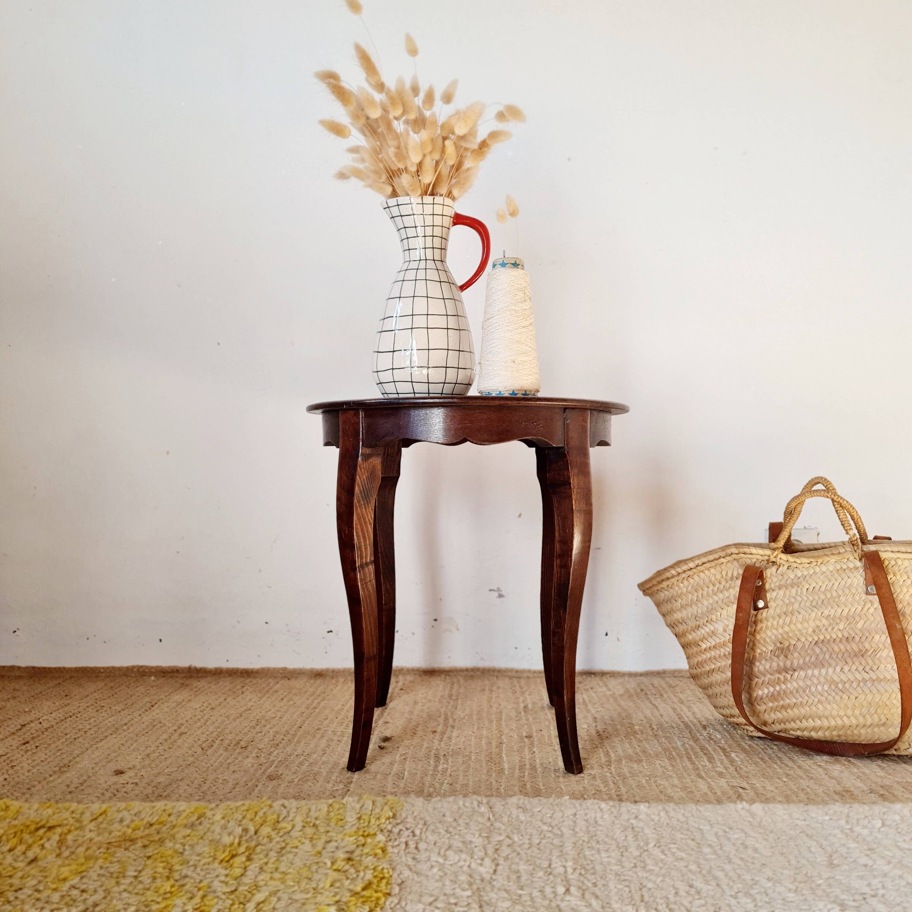 Vintage solid wood side table with curved legs.