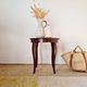 Vintage solid wood side table with curved legs.
