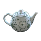 Green plant-decorated teapot