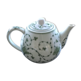 Green plant-decorated teapot