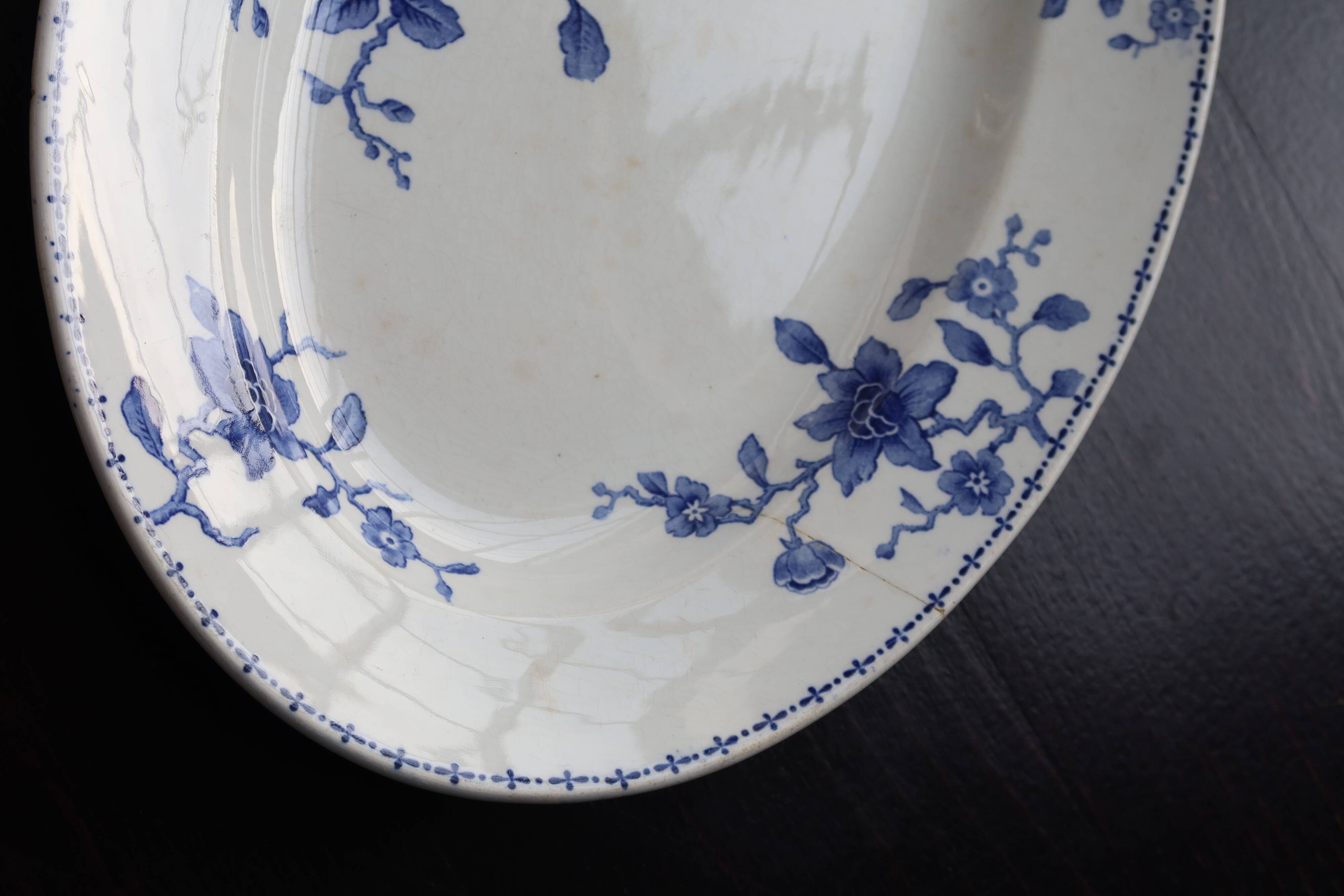 Antique serving dish in white and blue earthenware.