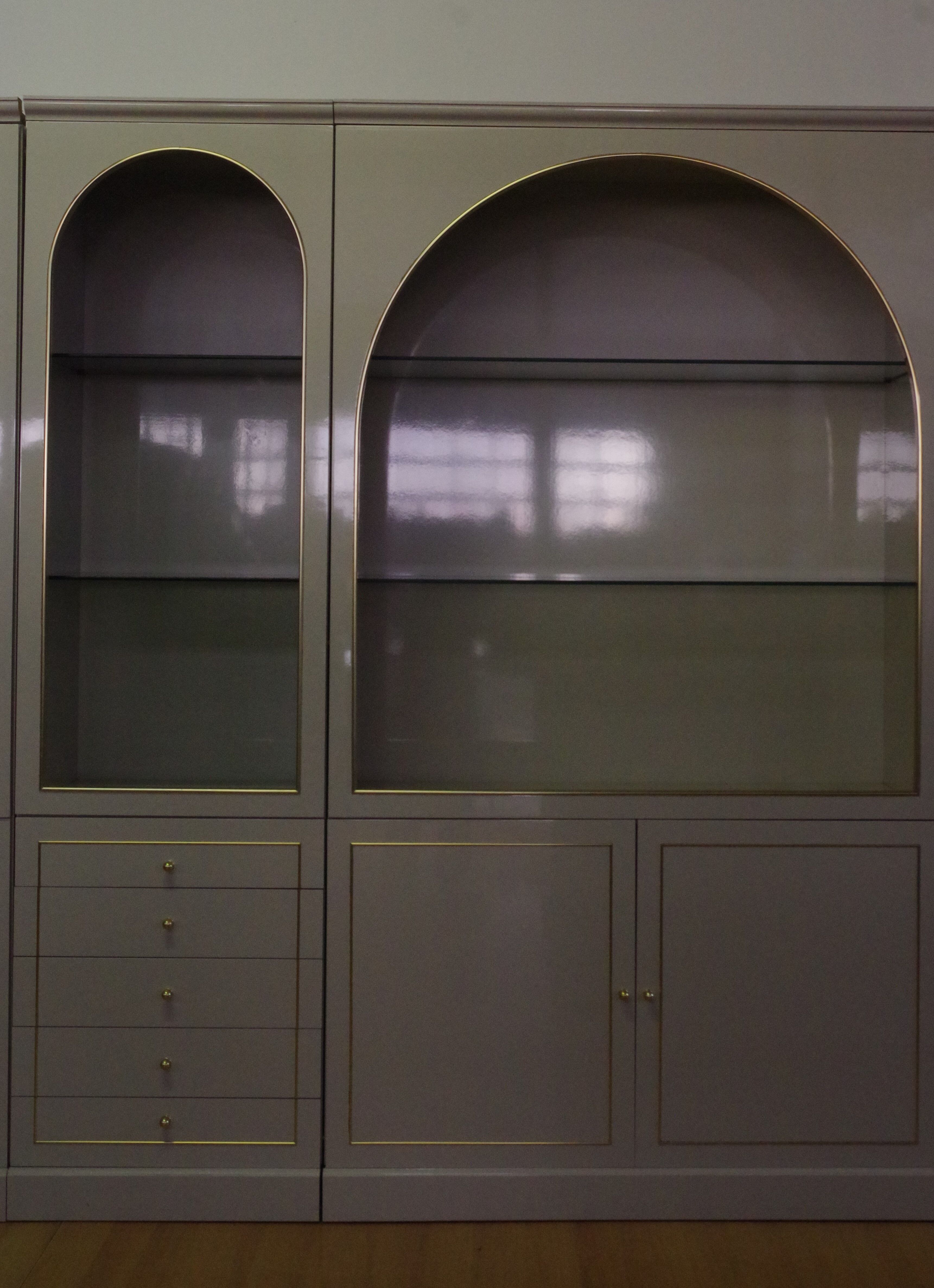 Showcases in lacquered wood, glass and brass  1970s, set of 4