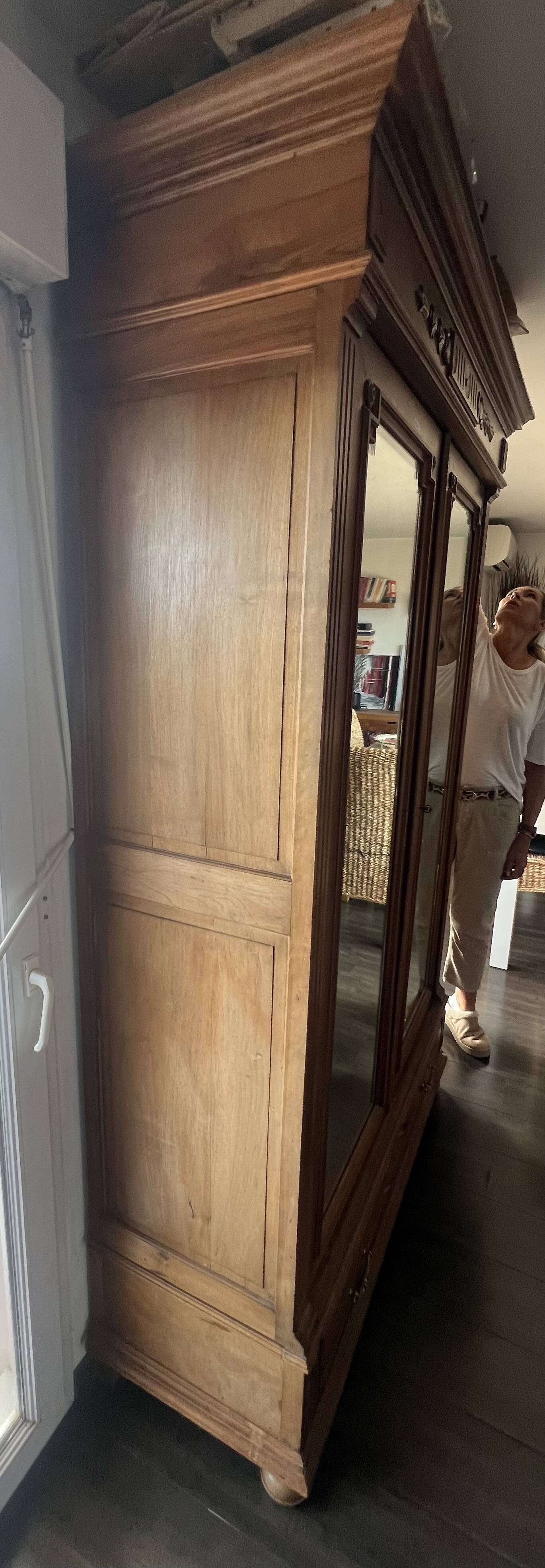 Walnut wardrobe with mirror doors.
