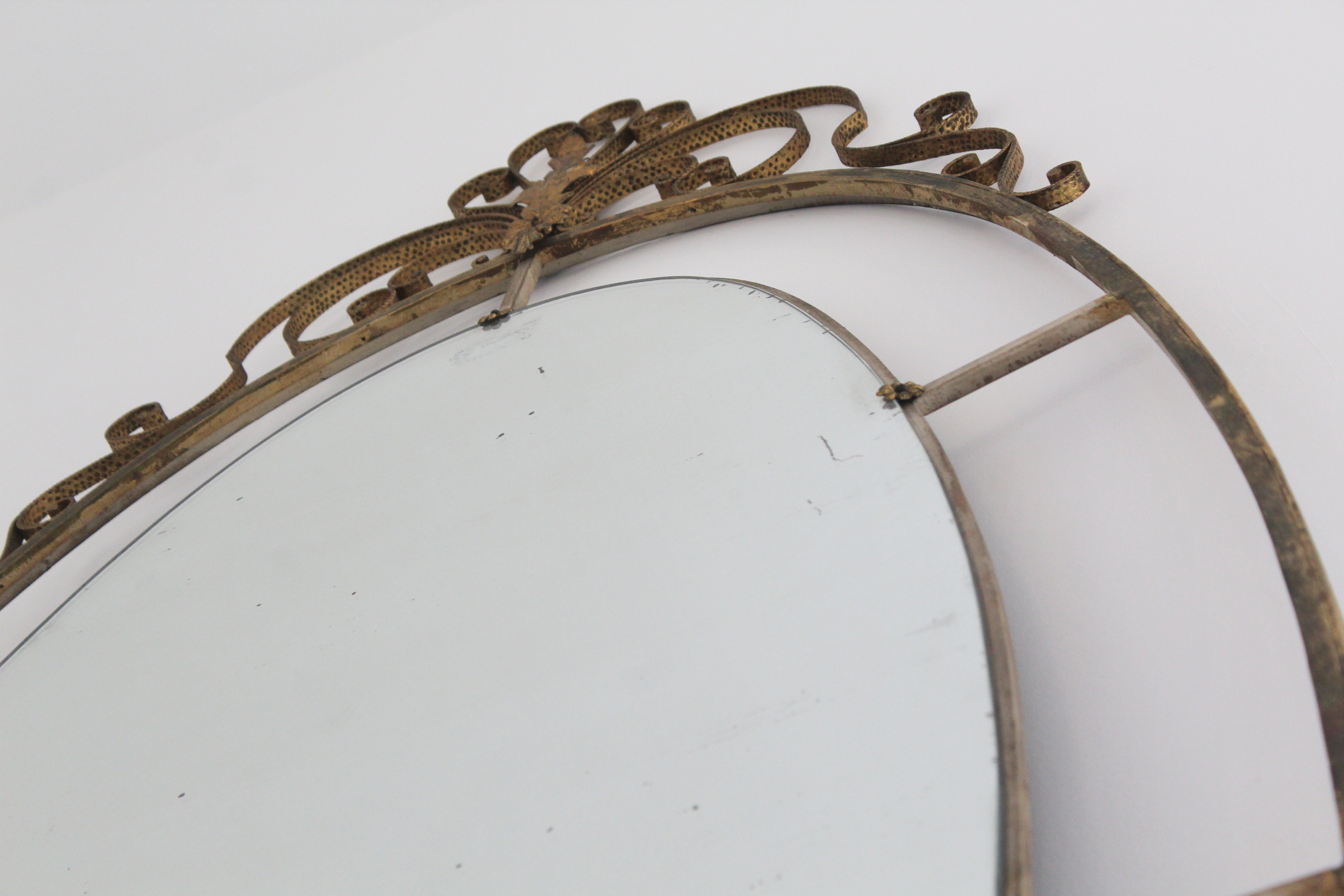 Oval mirror in art deco brass, Italy 1940s.