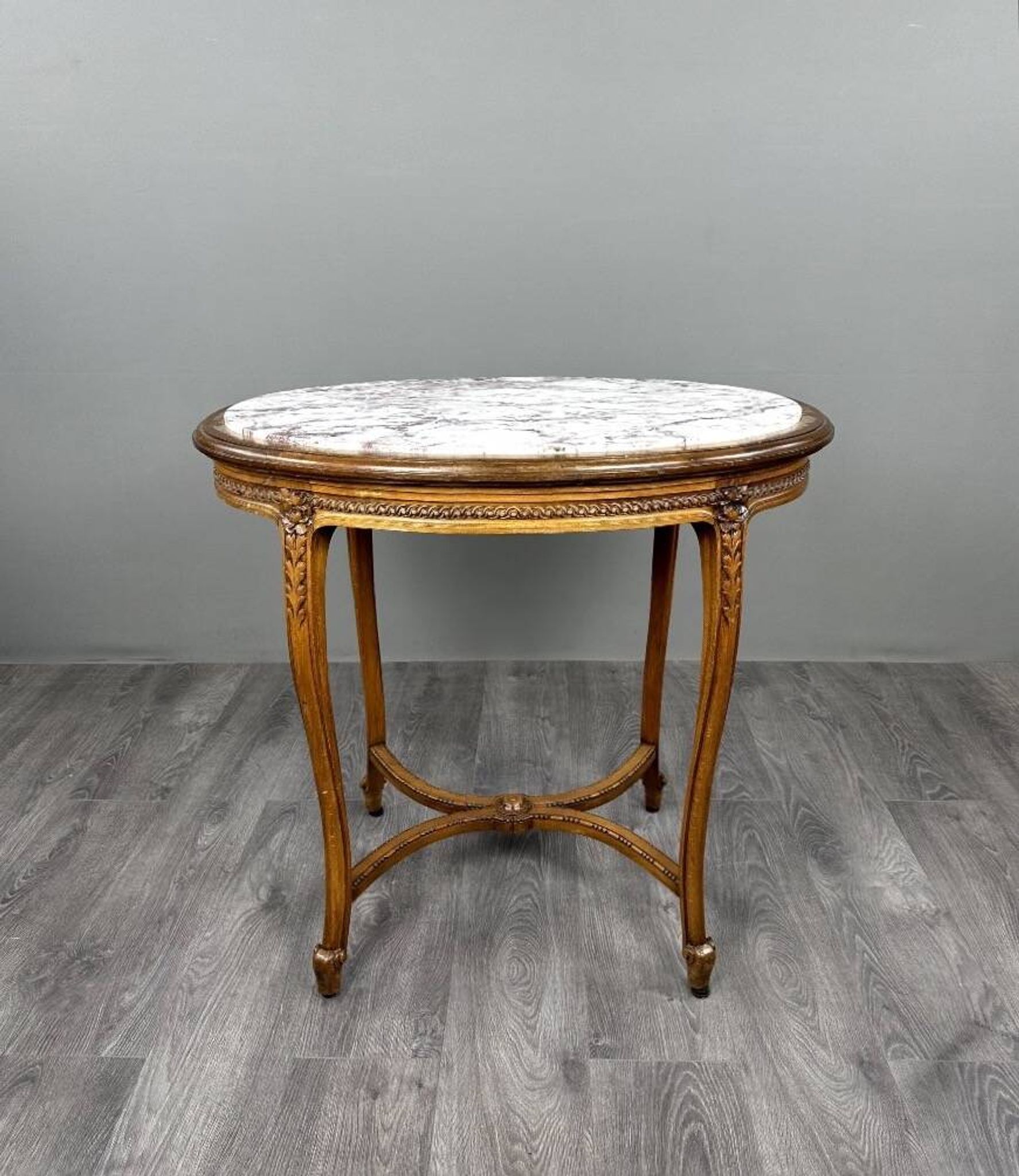 Oval guéridon table in carved wood and marble, Louis XVI style, 19th century.