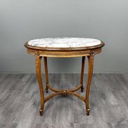 Oval guéridon table in carved wood and marble, Louis XVI style, 19th century.