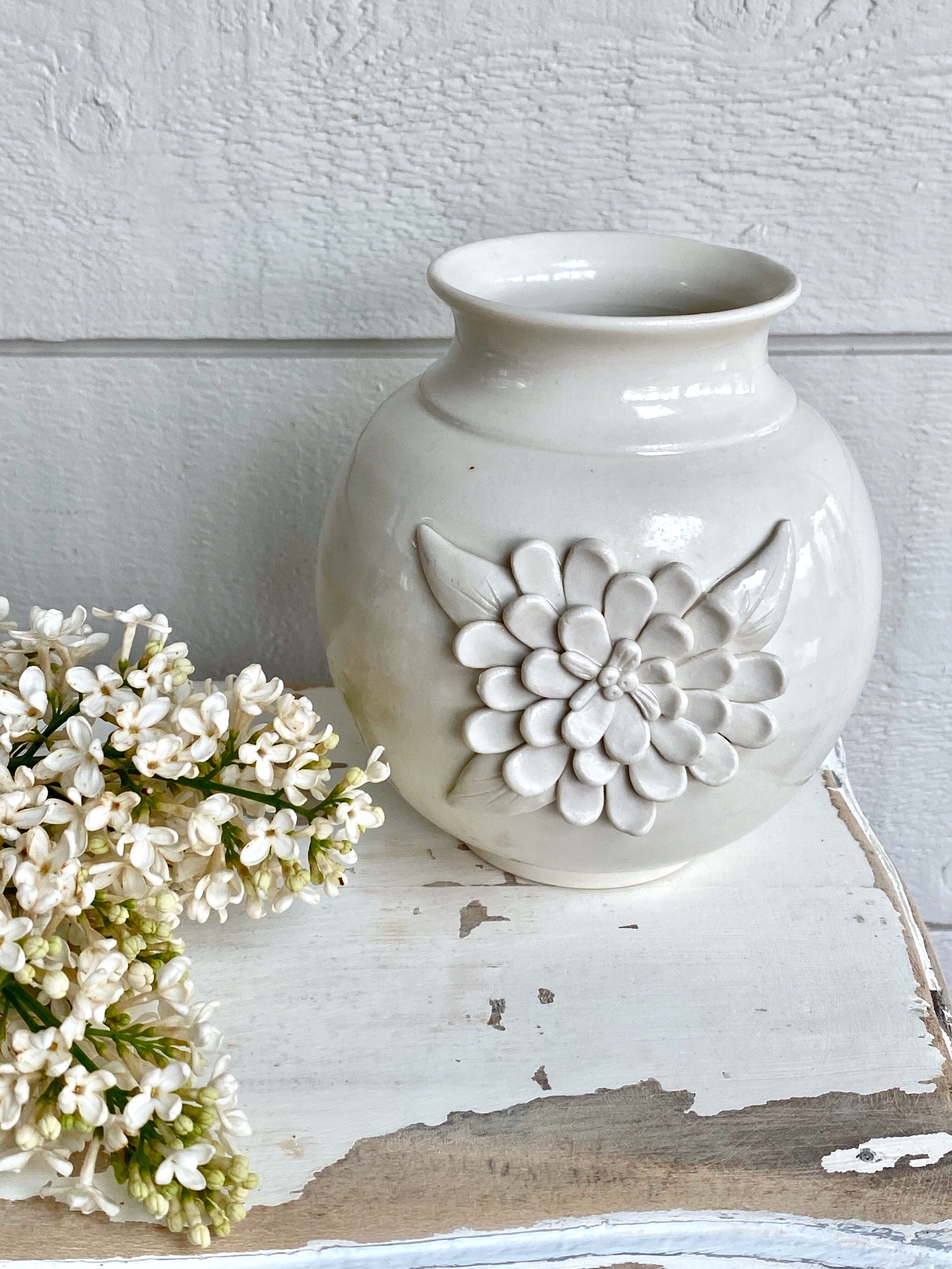 Small ceramic vase with floral relief