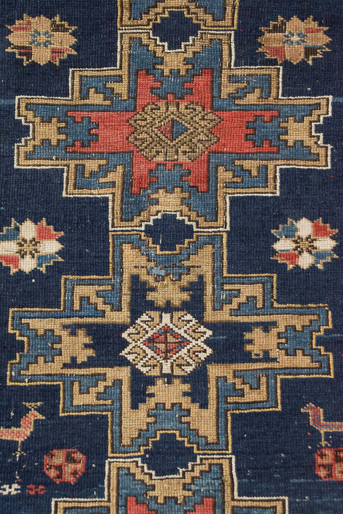 Handwoven blue ground persian rug with bird-like figures