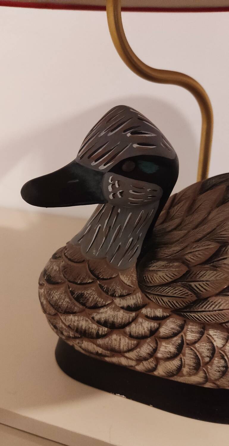Decorative table lamp with a sculpted duck-shaped base and painted finish.