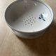 Fruit strainer in earthenware, Pornic, lily flower design.