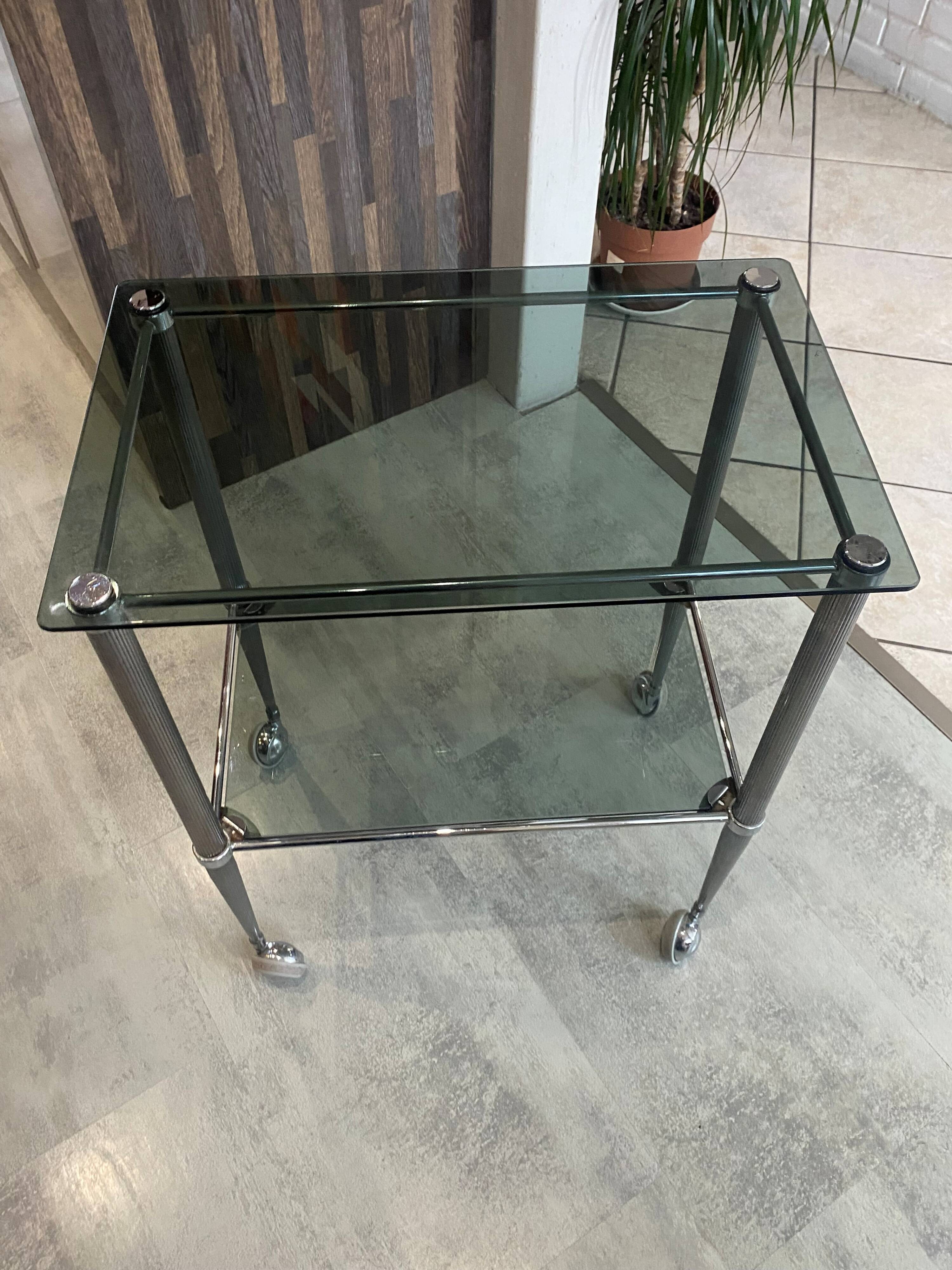 Serving dessert trolley with 2 smoked glass shelves and metal structure.